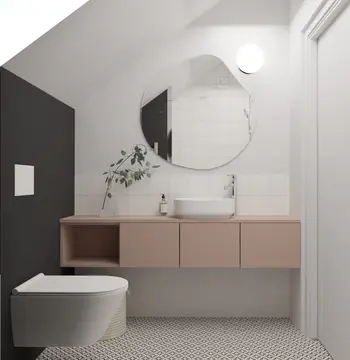 Nowoczesna łazienka z minimalistycznym wystrojem, różową szafką, okrągłym lustrem i rośliną.