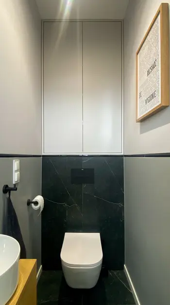 Minimalistyczna toaleta w nowoczesnym stylu z czarnymi i białymi elementami.