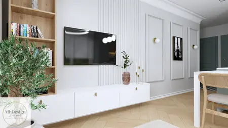 Wnętrze salonu z białą meblościanką, drewnianą podłogą i rośliną.