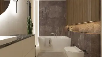Elegancka łazienka z wolnostojącą wanną, dużymi płytkami kamiennymi na ścianie i drewnianymi szafkami. Stonowana kolorystyka i subtelne oświetlenie dodają wnętrzu ciepła i luksusu.