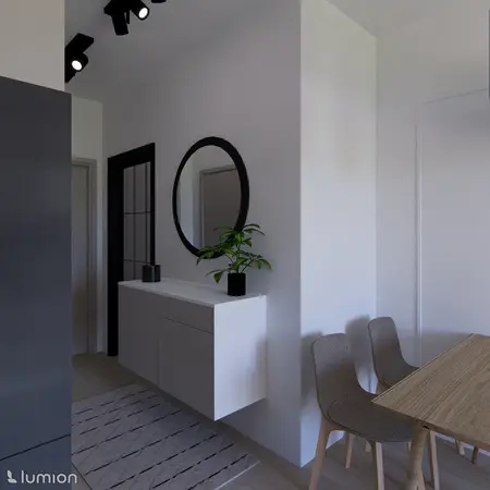 Przedpokój w stylu minimalistycznym z białą komodą i okrągłym lustrem.