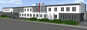 Widok budynku z szaro-białą elewacją i zielonymi krzewami, styl industrialny i nowoczesny.
