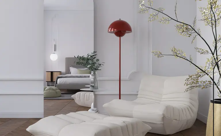 Wnętrze salonu w stylu minimalistycznym z białymi meblami i czerwonym lampą.