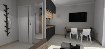 Wnętrze kuchni z drewnianymi meblami, industrialnymi i minimalistycznymi akcentami.