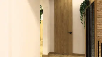 Wnętrze holu z drewnianymi akcentami i roślinnością, styl boho i nowoczesny.