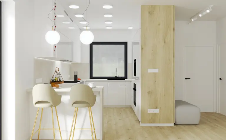Kuchnia minimalistyczna z białymi meblami i drewnianymi elementami, nowoczesne oświetlenie.