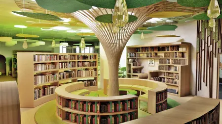 Współczesna biblioteka z drewnianymi regałami i zielonymi detalami