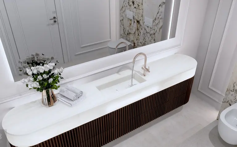 Nowoczesna łazienka z minimalistycznym designem, białą umywalką i brązową szafką.
