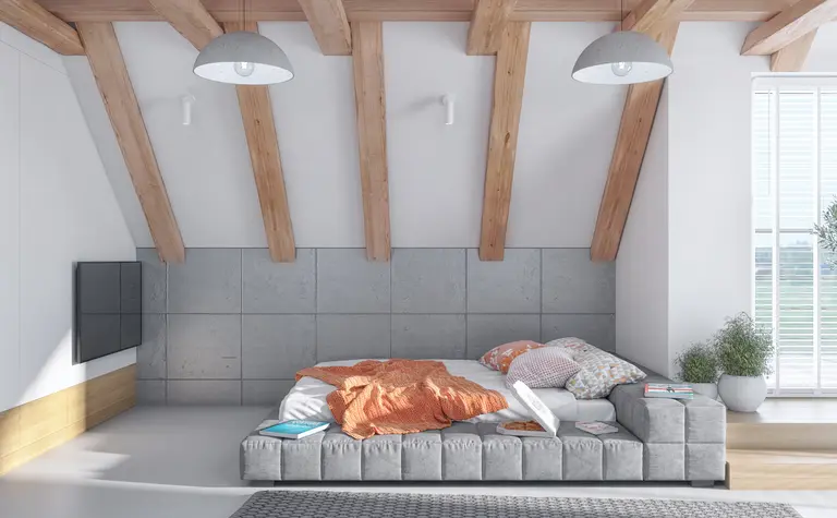Poddasze z szarymi ścianami i drewnianymi belkami, nowoczesne i skandynawskie.