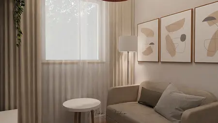 Współczesny salon z beżową sofą, lampą i obrazami.