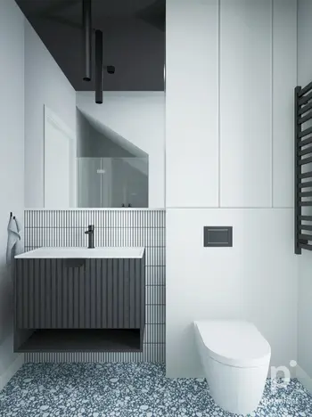 Nowoczesna łazienka z minimalistycznym designem, białą umywalką i szarym wykończeniem.