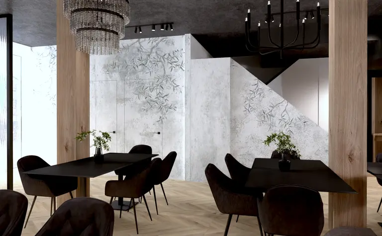 Wnętrze restauracji w stylu industrialnym z czarnymi stołami i drewnianymi akcentami.