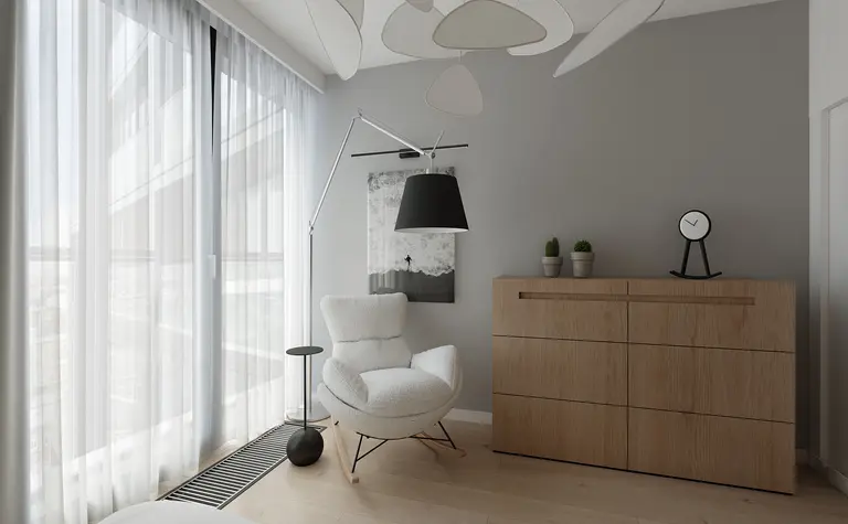 Styl minimalistyczny wnętrza z białym fotelem i drewnianą komodą.