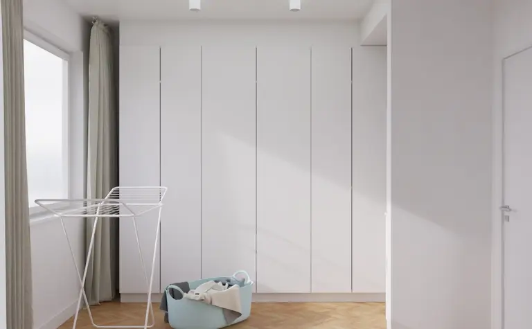 Przedpokój w stylu japandi, minimalistycznym i nowoczesnym z białymi meblami.