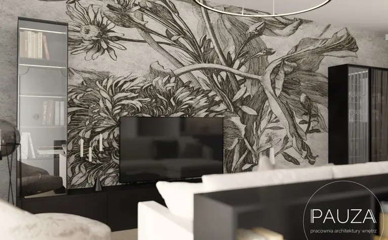 Nowoczesny salon z telewizorem i muralem roślinnym na ścianie.