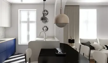 Wnętrze kuchni w stylu art deco i nowoczesnym z niebieskimi meblami i białym blatem.