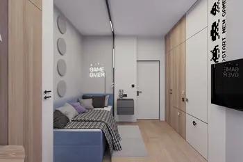 Wnętrze pokoju w stylu industrialnym i minimalistycznym z niebieską kanapą.