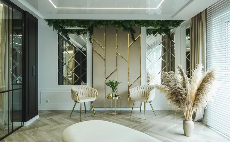 Stylowe wnętrze salonu z białymi fotelami i złotymi akcentami, nowoczesne i glamour.