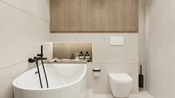 Nowoczesna łazienka w stylu japandi z białą wanną, minimalistycznymi meblami i drewnianymi detalami.