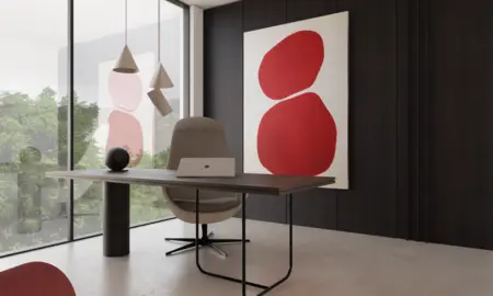 Wnętrze gabinetu z nowoczesnym biurkiem, minimalistycznymi lampami i czerwoną grafiką.