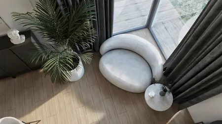Wnętrze nowoczesnego salonu z jasną sofą i roślinnością.