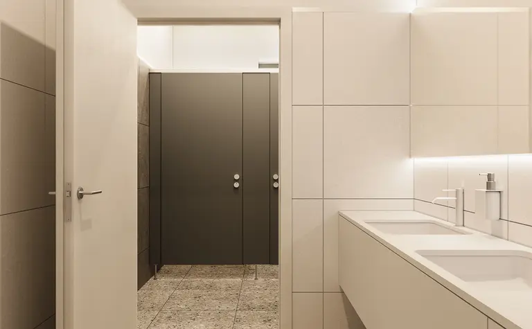 Wnętrze nowoczesnej łazienki z minimalistycznym designem i szarymi płytkami.