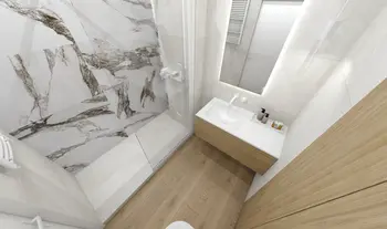 Nowoczesna łazienka z minimalistycznym designem, białą umywalką i drewnianymi elementami.
