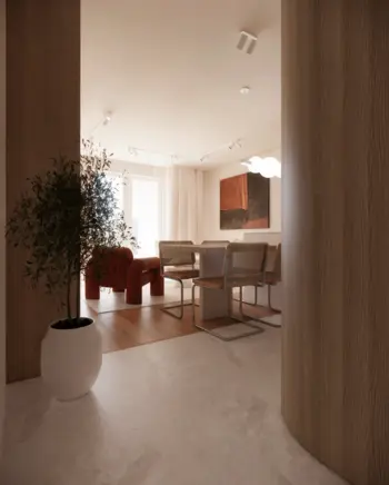Wnętrze jadalni w stylu minimalistycznym z drewnianym stołem, czerwonym fotelem i rośliną.
