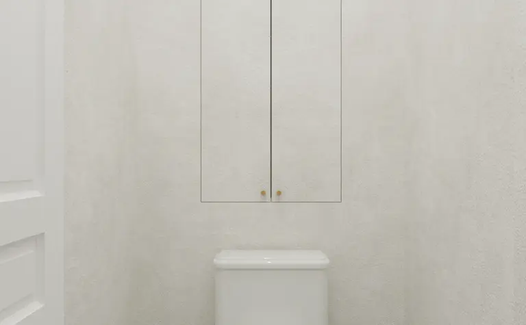 Toaleta w stylu art deco z białą ceramiką i szarym wykończeniem, minimalistyczne detale.