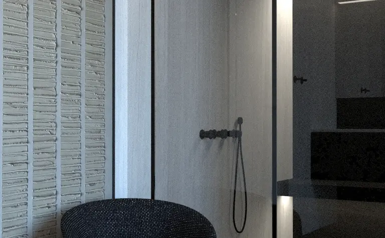 Wnętrze łazienki w minimalistycznym stylu z szarymi ścianami i czarnym fotelem.