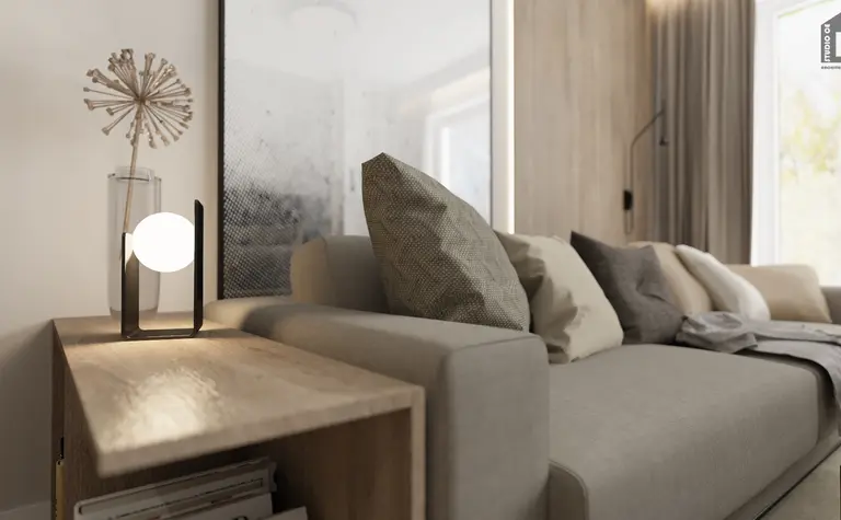 Wnętrze salonu z minimalistyczną sofą i lampą w stylu industrialnym.