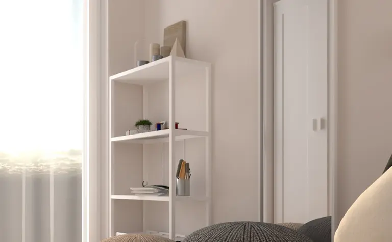 Wnętrze pokoju z białymi meblami, szarymi akcentami i minimalistycznym designem.