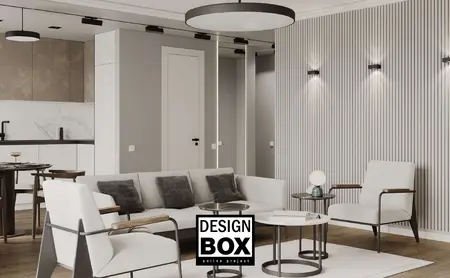 Wnętrze salonu minimalistycznego z szarymi ścianami, białą sofą i drewnianymi akcentami.