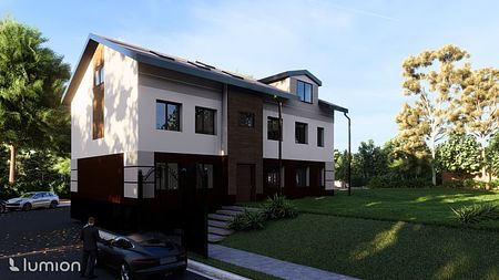 Nowoczesny dom jednorodzinny z brązowymi i białymi detalami, otoczony zielenią.