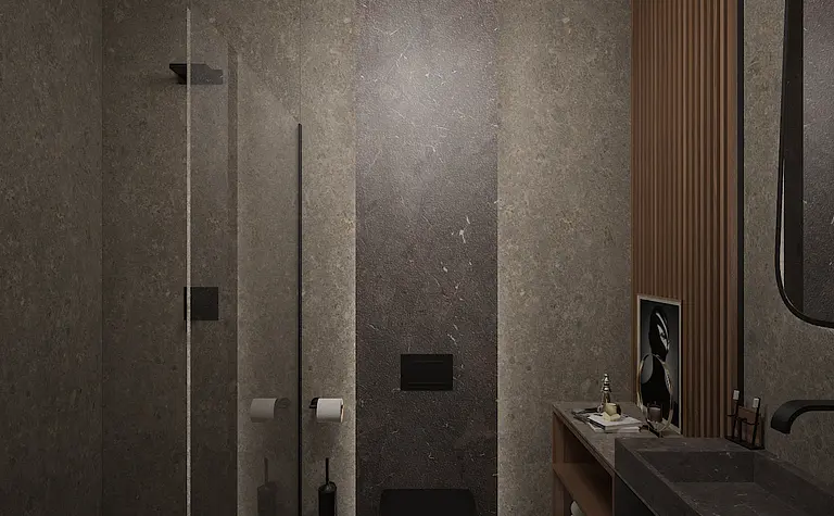 Wnętrze łazienki z minimalistycznym designem, szarymi ścianami i nowoczesnymi akcesoriami.