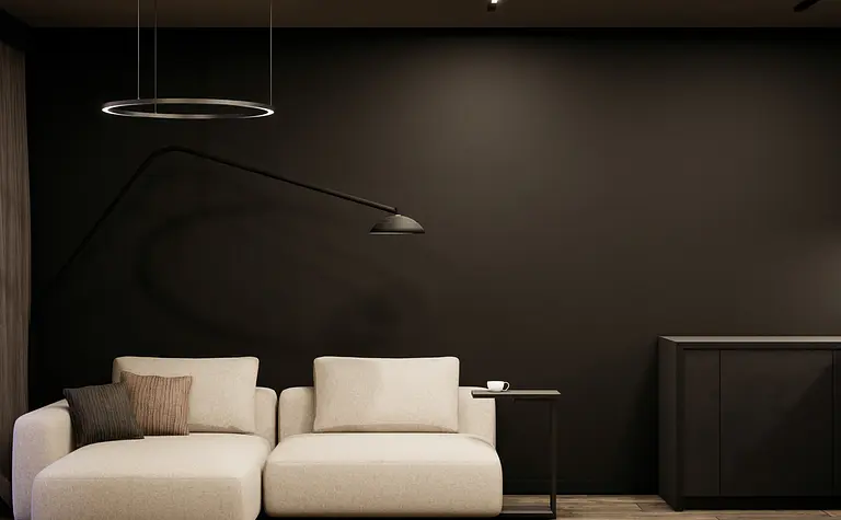 Wnętrze salonu z minimalistycznym designem, jasna kanapa i ciemne akcenty.