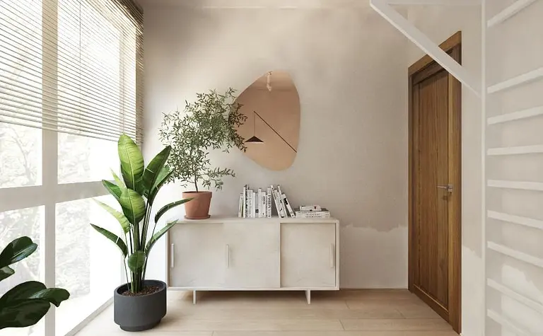 Wnętrze w stylach boho i japandi z białą komodą i roślinami.