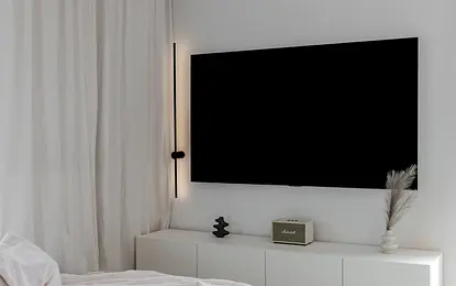 Wnętrze salonu w stylu art deco i boho z białą sofą.