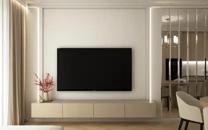 Nowoczesne wnętrze salonu z jasnymi meblami i telewizorem na ścianie.