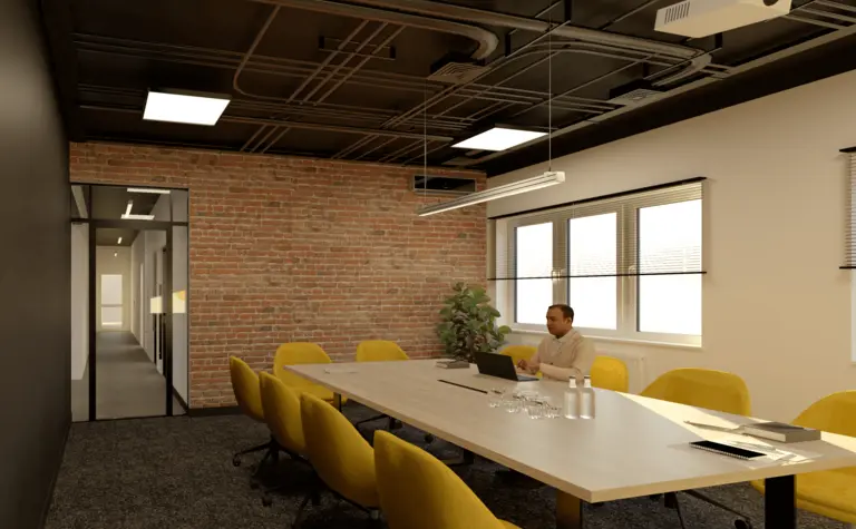Sala konferencyjna z ceglaną ścianą i żółtymi krzesłami, styl industrialny.
