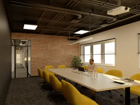 Sala konferencyjna z ceglaną ścianą i żółtymi krzesłami, styl industrialny.