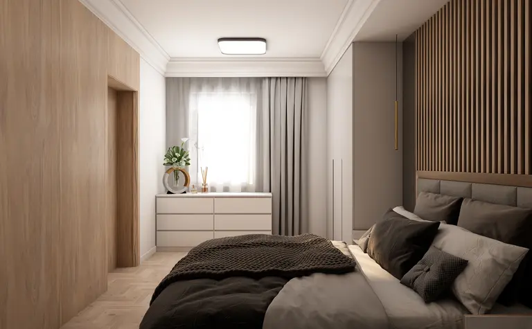 Wnętrze sypialni z nowoczesnym designem, drewnianą ścianą i białą komodą.