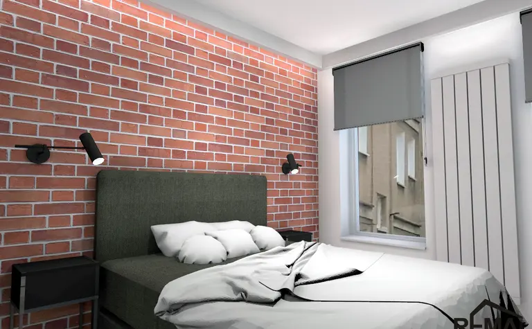 Wnętrze sypialni z ceglaną ścianą, szarym łóżkiem i minimalistycznymi lampami. Styl industrialny.