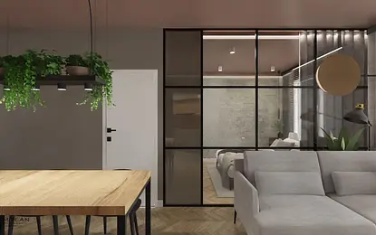 Wnętrze salonu z industrialnym stylem, szare ściany, drewniany stół i rośliny.