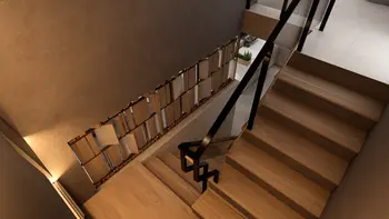 Wnętrze schodów z drewnianymi stopniami, szarymi ścianami i nowoczesnym balustradą.
