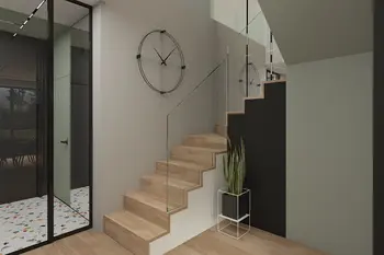 Korytarz w stylu minimalistycznym z drewnianymi schodami, czarnym zegarem i rośliną.