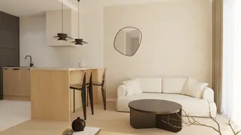 Wnętrze salonu w stylu japandi z minimalistycznym umeblowaniem i współczesnymi akcentami.