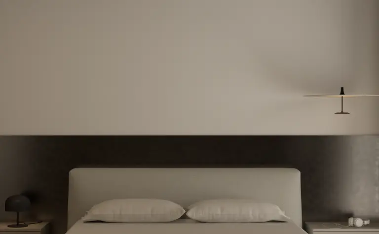 Minimalistyczna sypialnia z szarym łóżkiem i lampą.