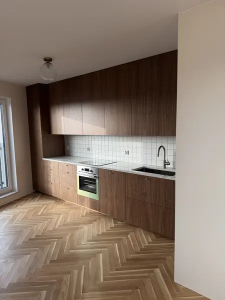 Kuchnia w stylu boho z drewnianymi meblami i białymi kafelkami.