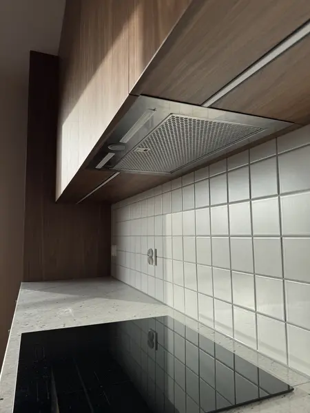 Nowoczesna kuchnia w stylu boho z drewnianymi meblami i białymi kafelkami.